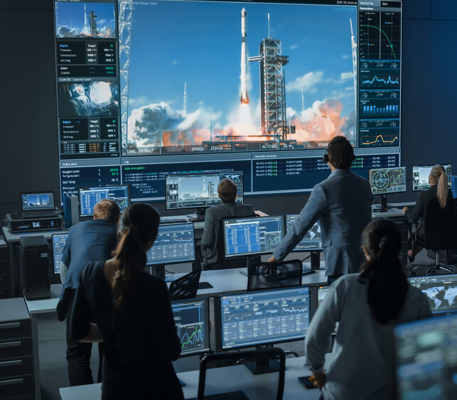 space simulation people in mission control during a rocket launch